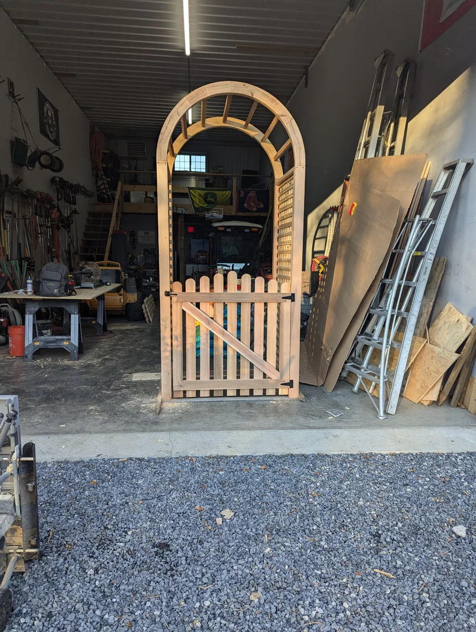 A curved garden arbor and gate taking shape in the workshop
